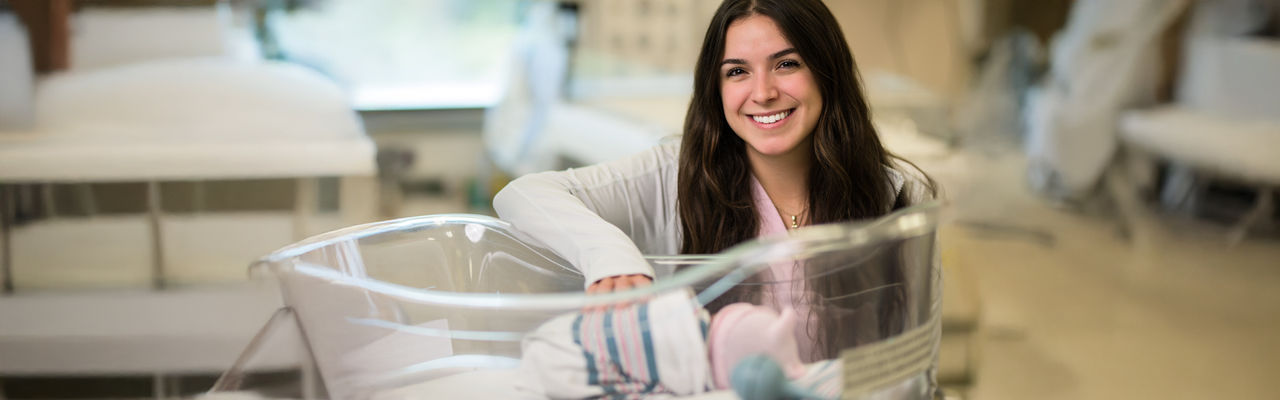 cp homepage hero labor and delivery nurse with baby mobile